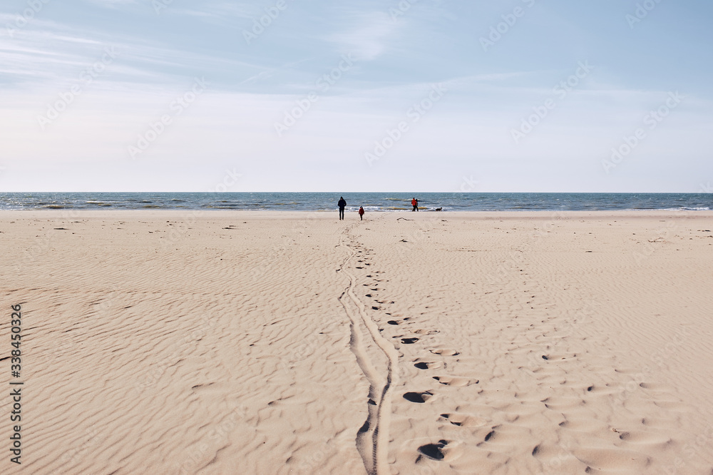 People with children walks on the sea beach. People with children walks on the sea beach.