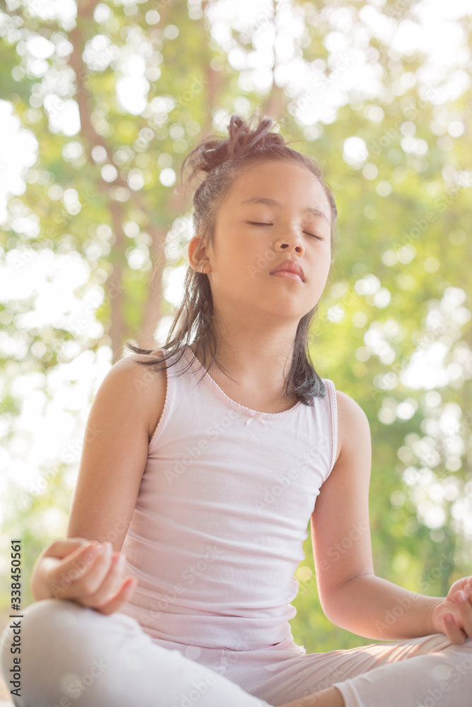 calmness and relax, female happiness.Horizontal, blurred background. little asian girl meditates while practicing yoga. freedom concept. calmness and relax, child happiness. toned picture healthy life calmness and relax, female happiness.Horizontal, blurred background. little asian girl meditates while practicing yoga. freedom concept. calmness and relax, child happiness. toned picture healthy life