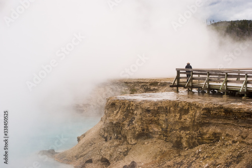 Steam and mist from Excelsior Geyser Crater envelop tourists on the boardwalk in Yellowstone National Park