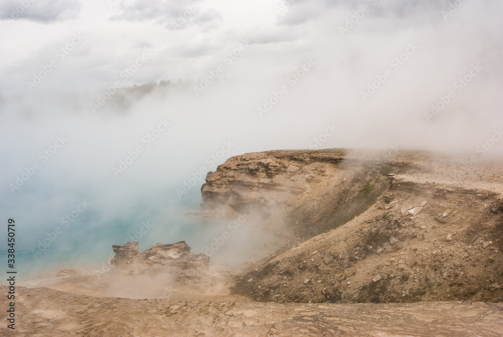 Excelsior Geyser Crater filled with steam and mist in Yellowstone National Park Excelsior Geyser Crater filled with steam and mist in Yellowstone National Park