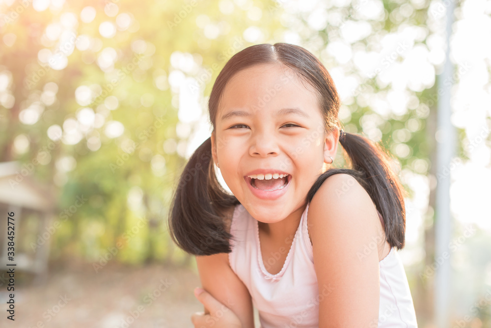 sweet little girl outdoors in the wind. portrait of attractive little student girl with beautiful. happy smiling child looking at camera - close-up, outdoors. jolly nature childhood leisure concept. sweet little girl outdoors in the wind. portrait of attractive little student girl with beautiful. happy smiling child looking at camera - close-up, outdoors. jolly nature childhood leisure concept.