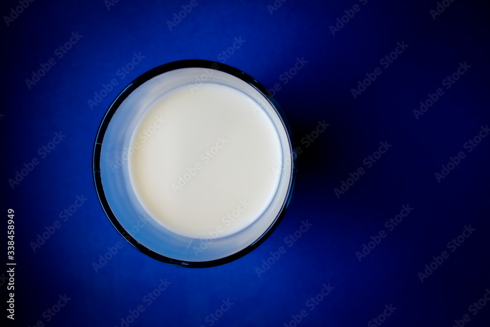 Glass of milk top view on with blue background Glass of milk top view on with blue background