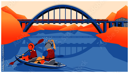 a couple kayak in a lake and takes photo of the train and bridge