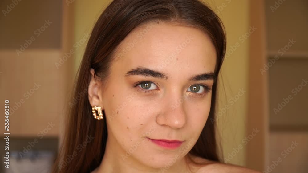 closeup of a beautiful young girl demonstrating her nude makeup the final result closeup of a beautiful young girl demonstrating her nude makeup the final result