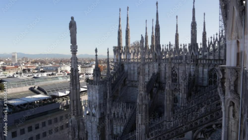 Duomo di Milano view from the rooftop with the Milan cityscape in the back, wide pan during daytime Duomo di Milano view from the rooftop with the Milan cityscape in the back, wide pan during daytime