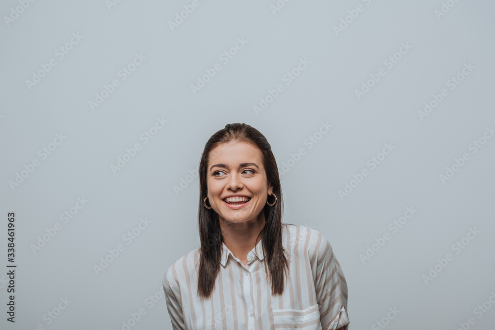 Beautiful smiling girl looking away isolated on grey Beautiful smiling girl looking away isolated on grey