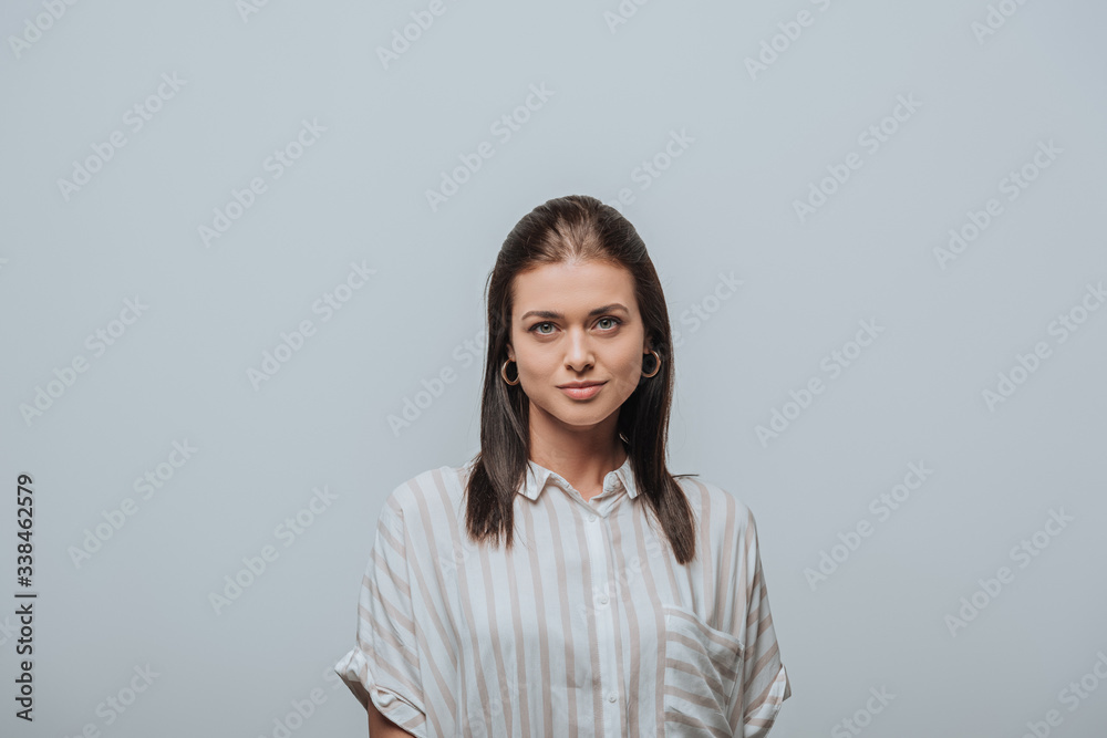 Beautiful young woman looking at camera isolated on grey Beautiful young woman looking at camera isolated on grey