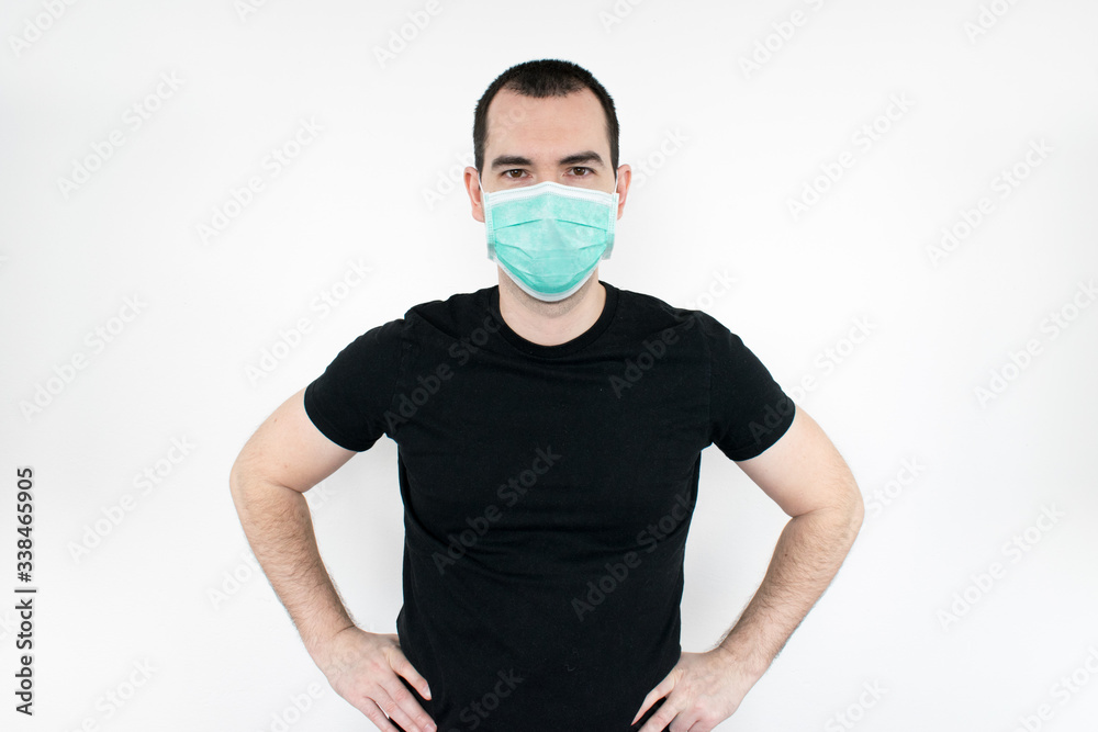 male man young black t-shirt stand white background wear mask on face. protect yourself. save life coronavirus symbol male man young black t-shirt stand white background wear mask on face. protect yourself. save life coronavirus symbol