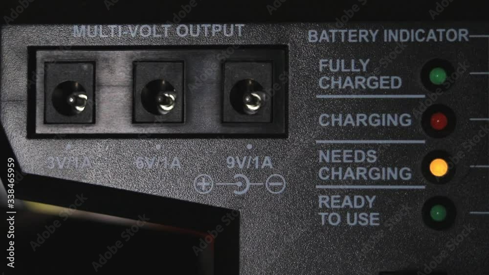 Battery indicator with the inscriptions 'need to load'. Yellow charge witness light. Branch with voltage indication. Battery indicator with the inscriptions 'need to load'. Yellow charge witness light. Branch with voltage indication.