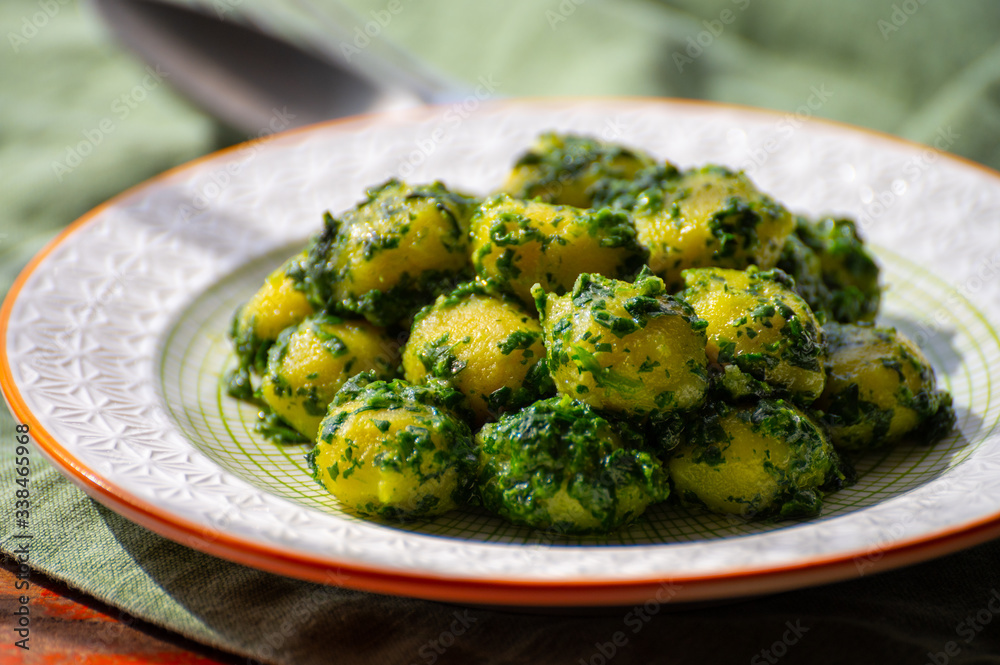 Tasty vegetarian food, italian potato gnocchi with green spinach filled with mozzarella cheese Tasty vegetarian food, italian potato gnocchi with green spinach filled with mozzarella cheese
