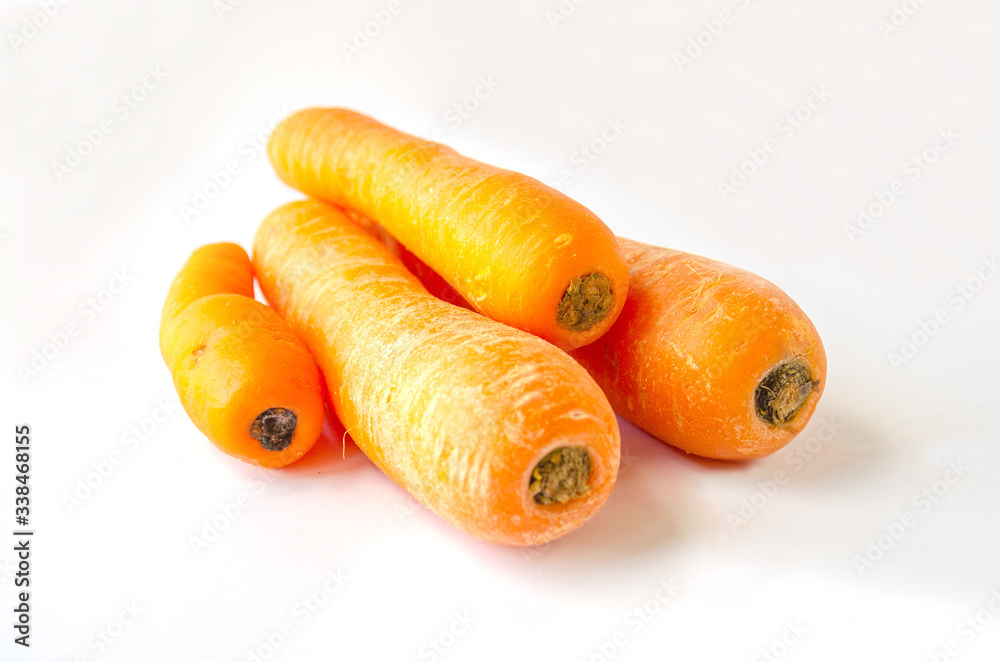 Raw carrots shot against a white background. Raw carrots shot against a white background.