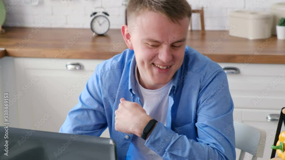 A man energetically communicates in online video chat, close-up. Home quarantine, social distancing, self isolation