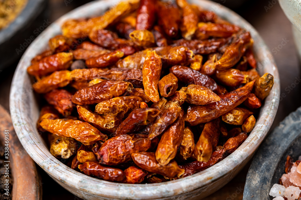 Indian spices collection, dried red hot chili peppers and another spices in clay bowls Indian spices collection, dried red hot chili peppers and another spices in clay bowls