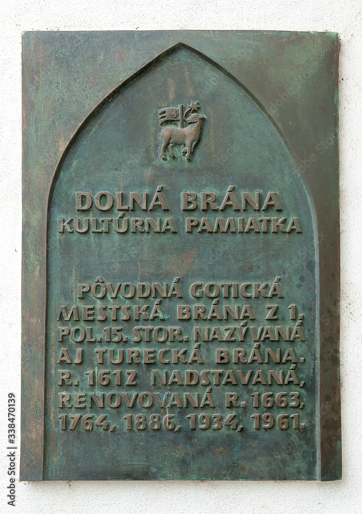 TRENCIN, SLOVAKIA - MAY 18, 2019: The bronze table placed on City Tower (Lower Gate) in Trencin. Western Slovakia. Central Europe. Bronze guide sign, located on the wall. TRENCIN, SLOVAKIA - MAY 18, 2019: The bronze table placed on City Tower (Lower Gate) in Trencin. Western Slovakia. Central Europe. Bronze guide sign, located on the wall.