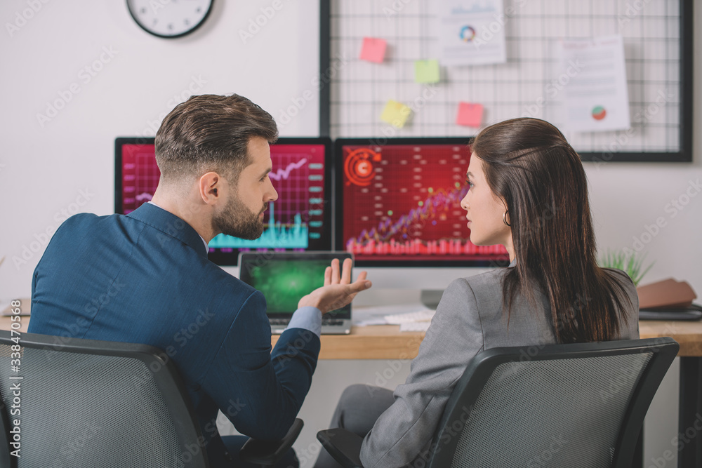 Back view of analysts planning protection for computer systems in office