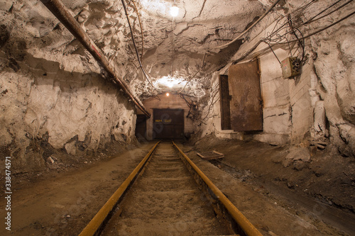 Underground gold mine shaft tunnel drift with rails and doors