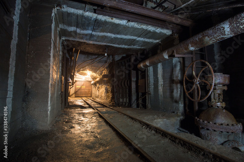 Underground gold mine shaft tunnel drift with rails and doors
