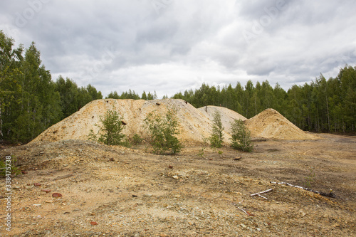 Dull landscape on abandoned mining site with surface dump photo