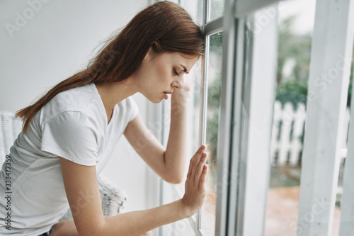 young woman looking out window