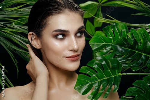 Beautiful woman green leaves Exotic tropics luxury