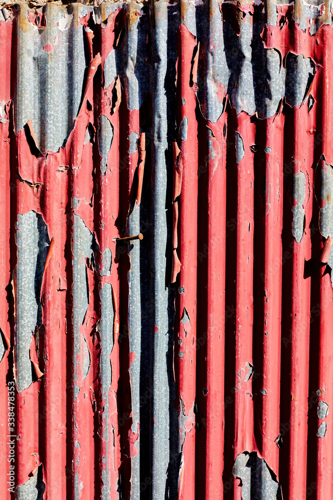 Old weathered corrugated sheet with peeled paint