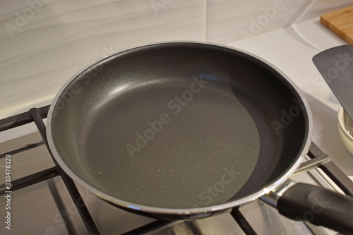 An empty frying pan on the stove, close-up.Cooking battery.