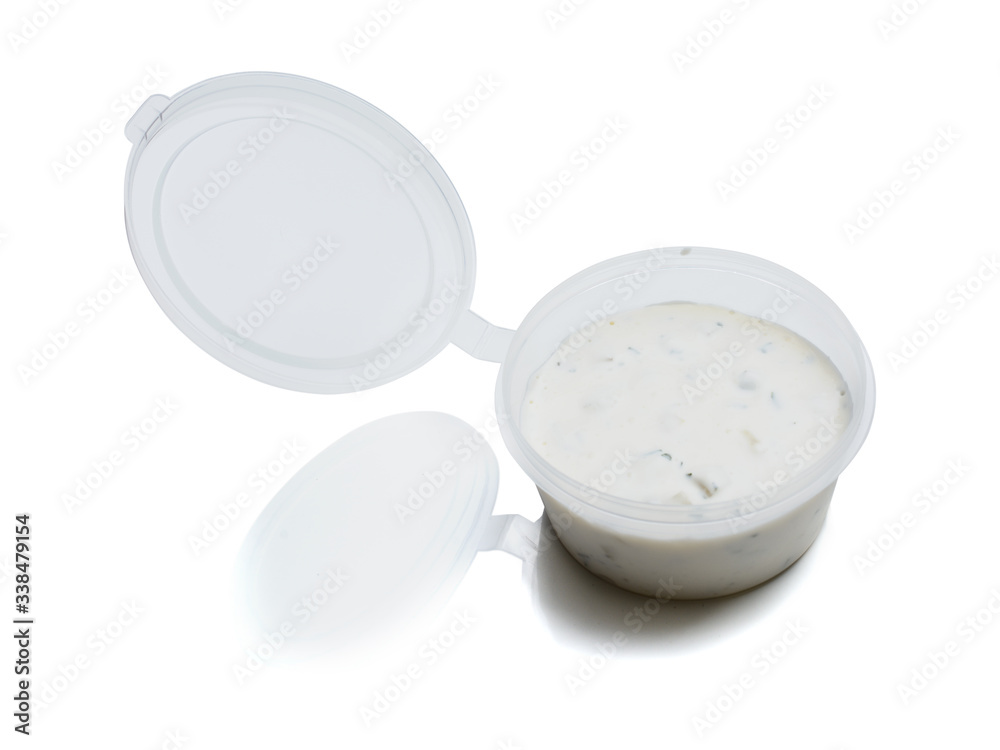 Tartar sauce in a plastic container for food delivery. Isolated on a white background with reflection Tartar sauce in a plastic container for food delivery. Isolated on a white background with reflection