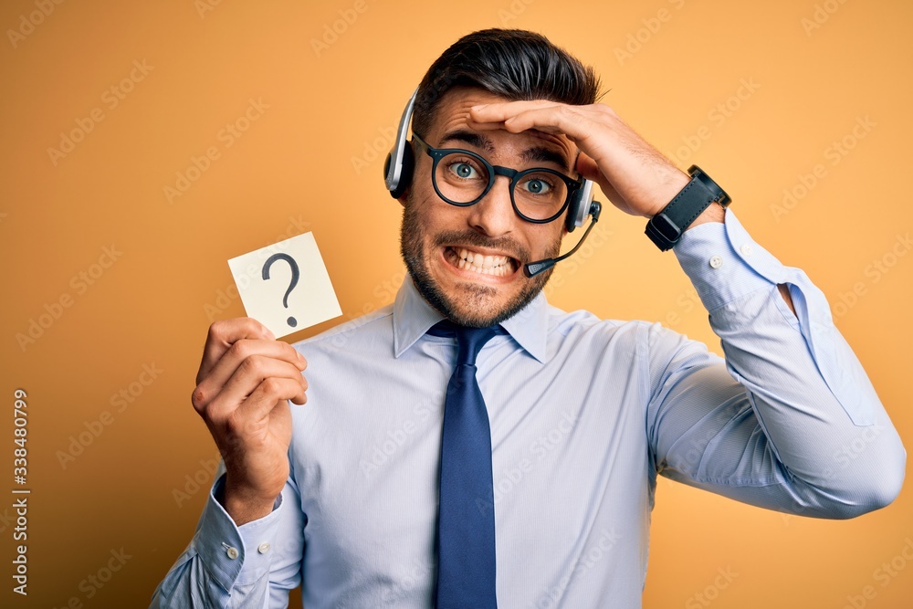 Business operator man with customer service headset from call center showing question mark stressed with hand on head, shocked with shame and surprise face, angry and frustrated. Fear and upset Business operator man with customer service headset from call center showing question mark stressed with hand on head, shocked with shame and surprise face, angry and frustrated. Fear and upset