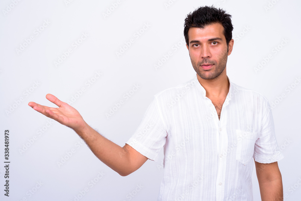 Portrait of handsome Turkish man showing something Portrait of handsome Turkish man showing something