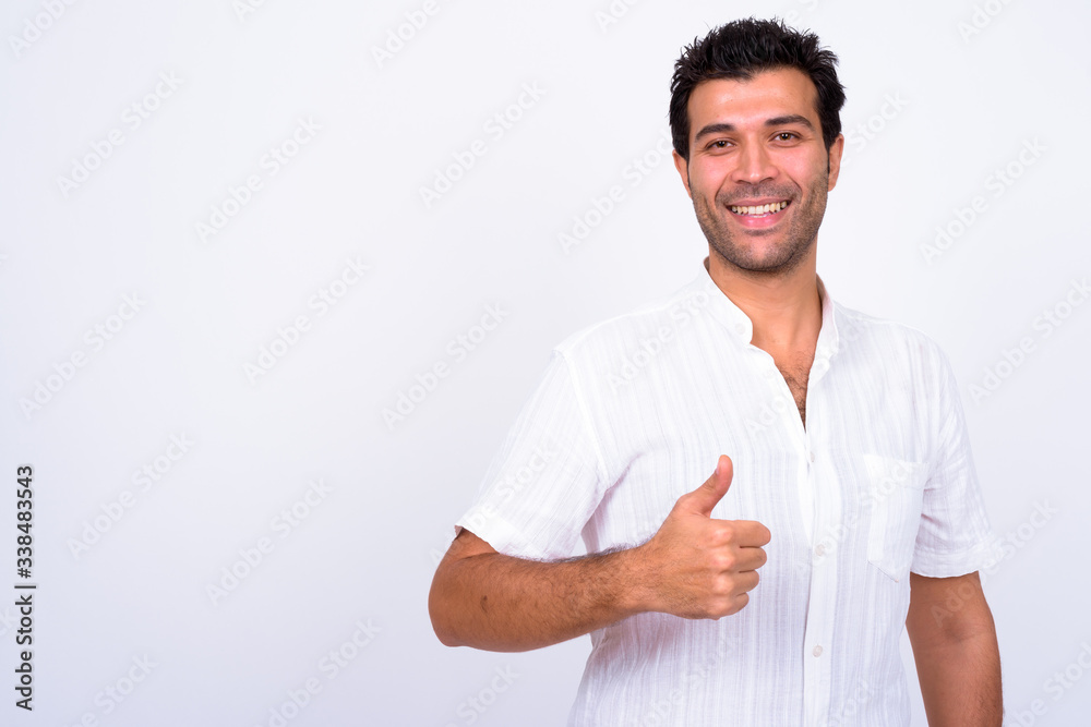 Portrait of happy handsome Turkish man giving thumbs up Portrait of happy handsome Turkish man giving thumbs up