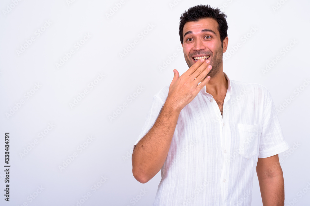 Portrait of happy handsome Turkish man looking surprised Portrait of happy handsome Turkish man looking surprised