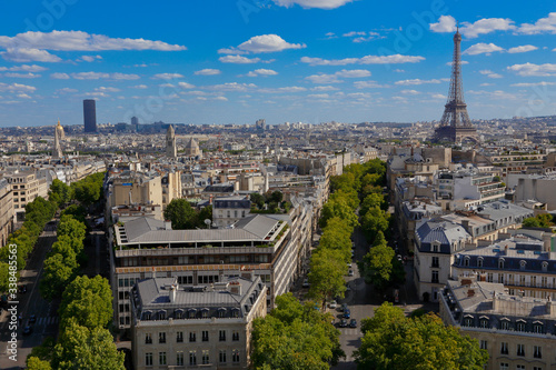 PARIS, FRANCE, EUROPE -Aerial view of Paris, France and Eiffel Tower as seen from the Arch of Triumph on a sunny day with white puffy clouds, shot August 4, 2015