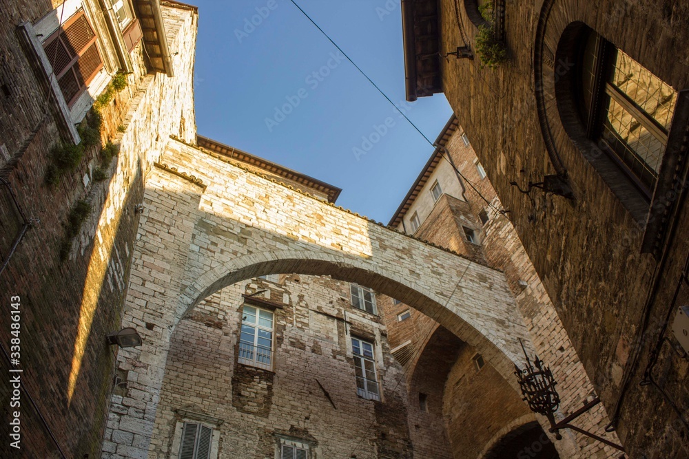 ancient historic arch between houses in the medieval part of Perugia city, Italy