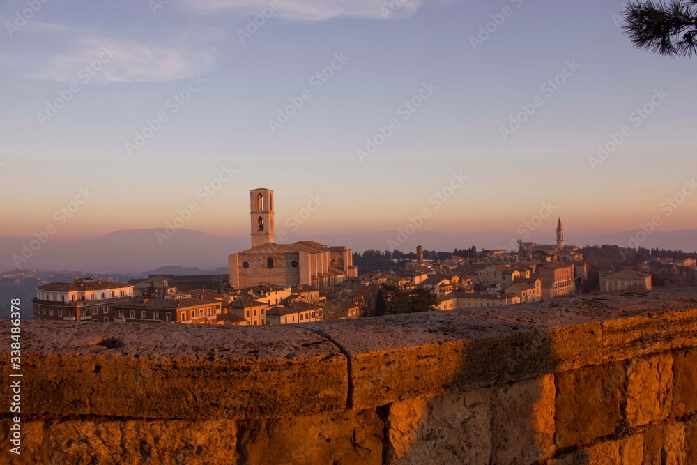 Perugia cityscape from the top at sunset, with San Domenico church in the background