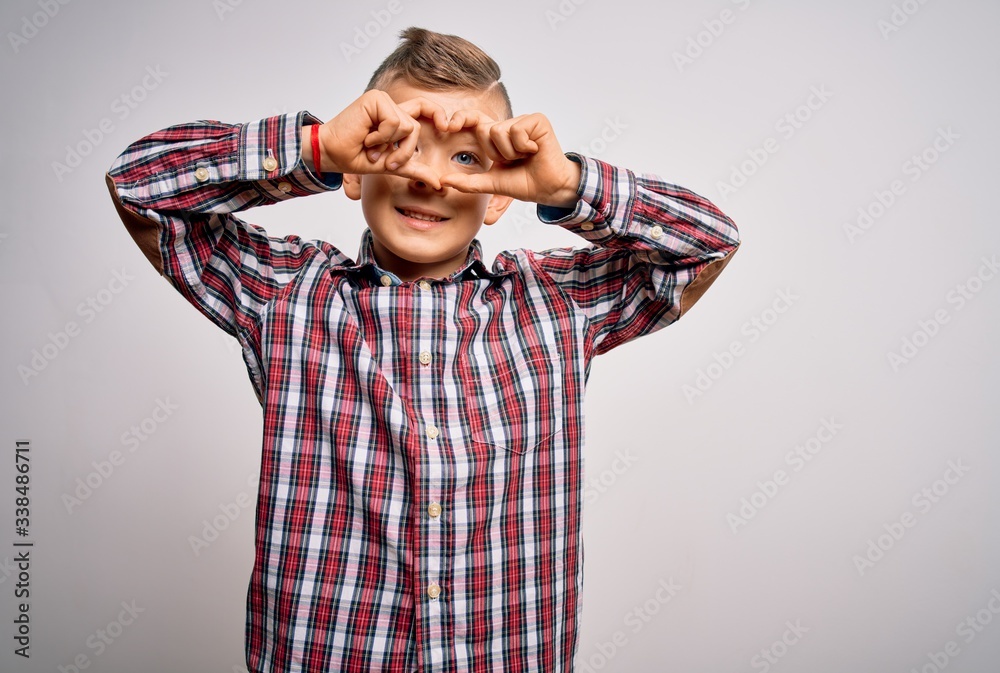 Young little caucasian kid with blue eyes wearing elegant shirt standing over isolated background Doing heart shape with hand and fingers smiling looking through sign Young little caucasian kid with blue eyes wearing elegant shirt standing over isolated background Doing heart shape with hand and fingers smiling looking through sign