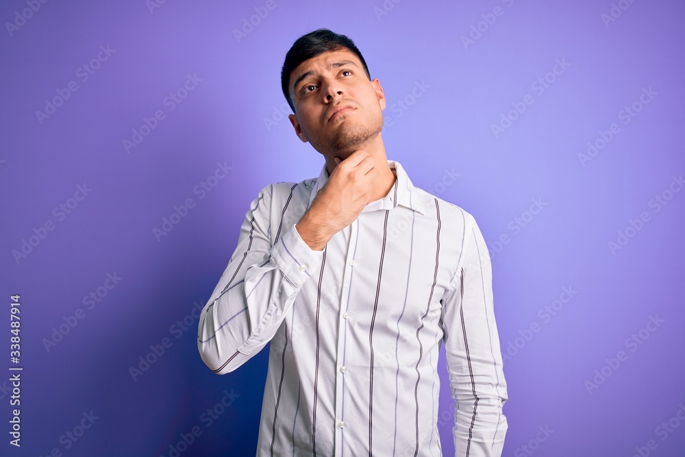 Young handsome hispanic man wearing elegant business shirt standing over purple background Touching painful neck, sore throat for flu, clod and infection