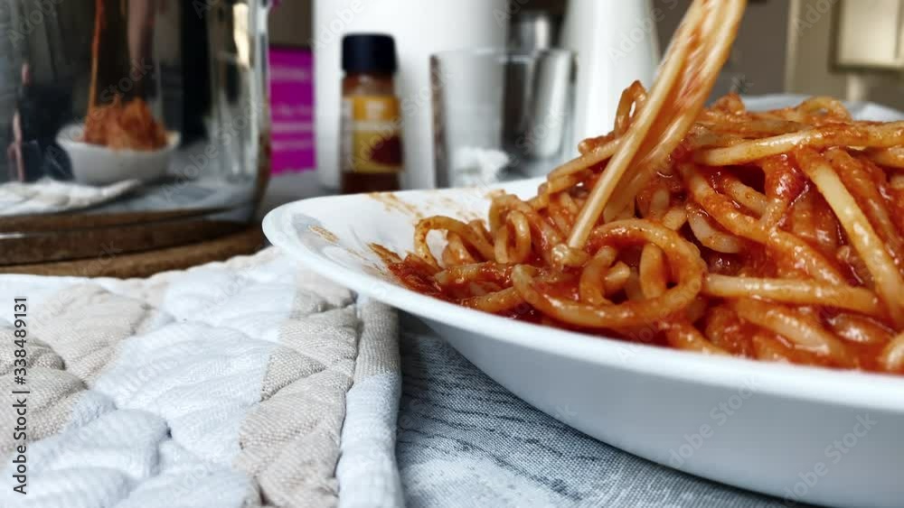 eating tomato spaghetti with a fork. Italian cuisine.
