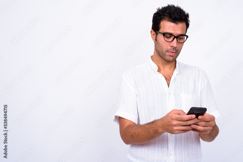 Portrait of handsome Turkish man with eyeglasses using phone Portrait of handsome Turkish man with eyeglasses using phone