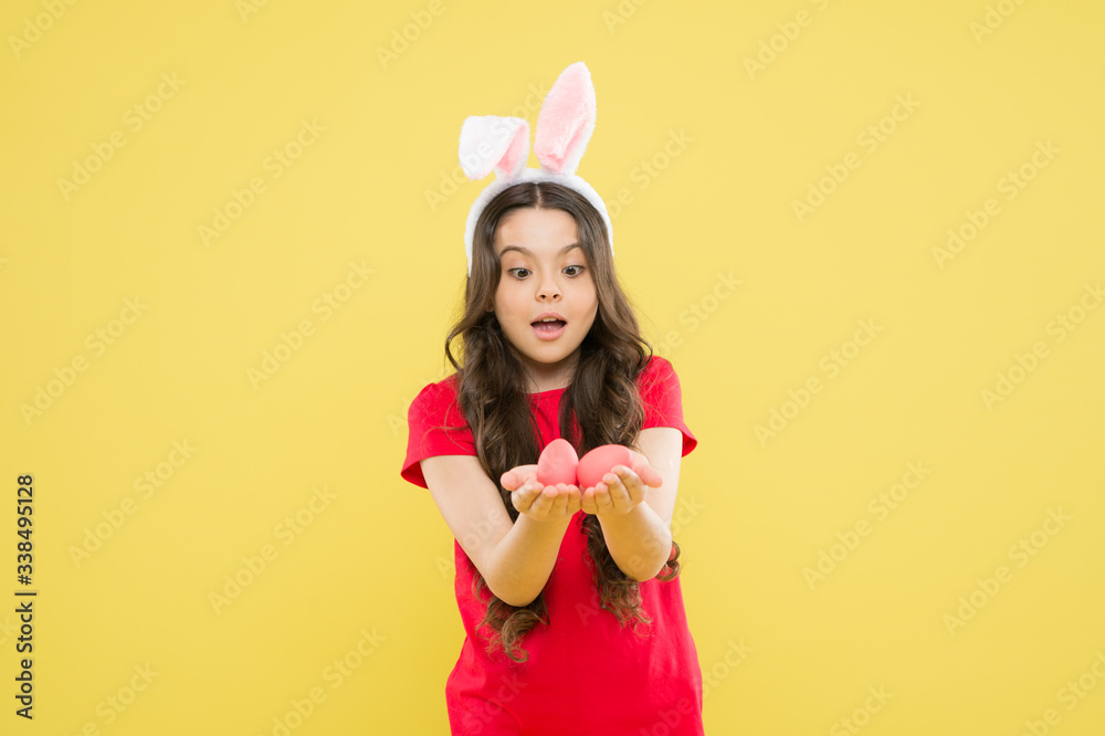 Collecting Easter eggs. Funny hare kid on egg hunt. small girl feel happiness. child with painted eggs. follow traditions. Funny preparing for Easter. Happy easter holiday. Playful beauty