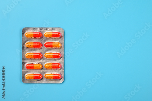 Pharmaceuticals Pills on a blue background. Empty space for text.