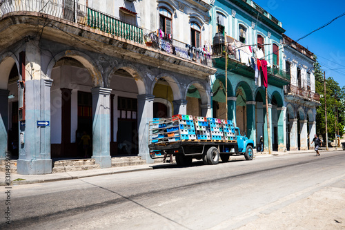 Street in Old Havana with delivery truck and colonial building exterior. © photogl