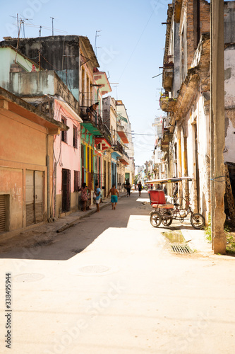 Morning in the street of sunny Old Havana in Cuba with a rickshaw.   © photogl