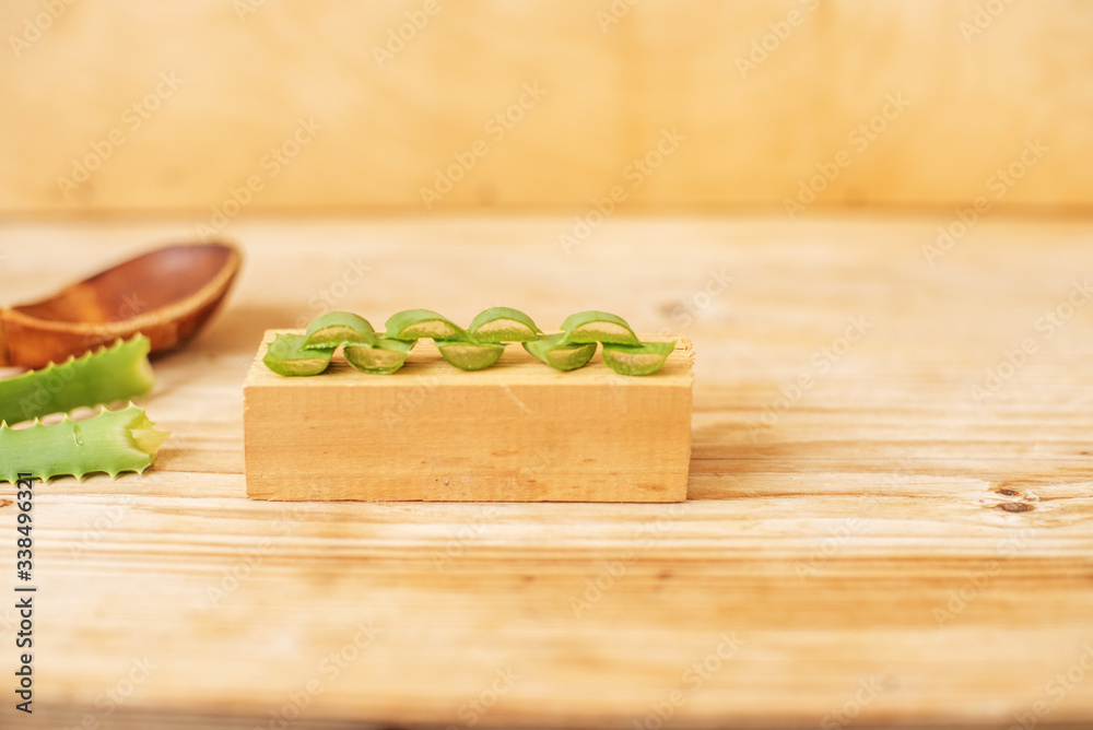 sliced and leaf of fresh aloe vera with aloe vera gel product on wooden background sliced and leaf of fresh aloe vera with aloe vera gel product on wooden background