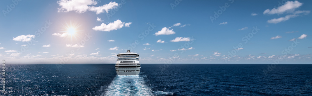 Naklejka premium Sailing cruise ship on the sea. Rear end of the vessel with a track of foam. Sunset view. Wide panoramic picture.
