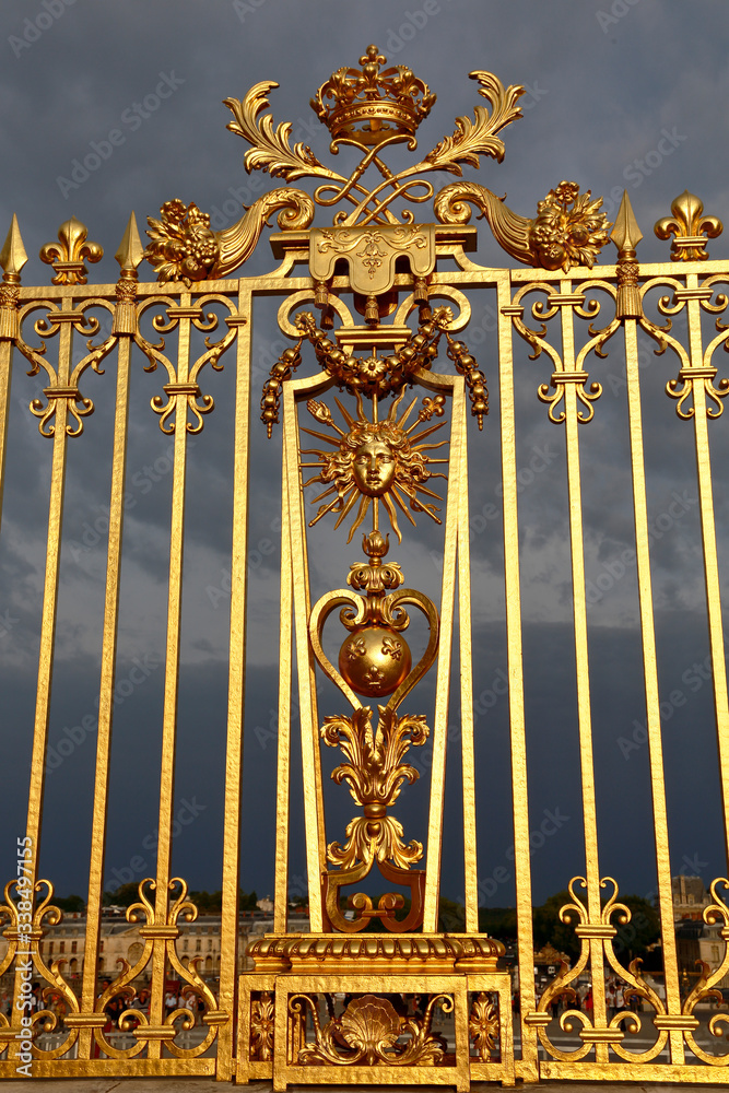 VERSAILLES, FRANCE - August 8, 2015: Main golden gates of the chateau de Versailles, Versailles, France.