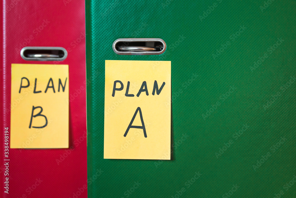 Two folders with stickers, on which plan a or b is written. Business planning. A spare option. Difficulties of enterprise management. Development options. Place for text, background blur. Two folders with stickers, on which plan a or b is written. Business planning. A spare option. Difficulties of enterprise management. Development options. Place for text, background blur.