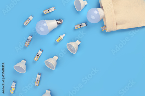 Several LED bulb on blue background. Saving energy concept. Ftat lay, top view, copy space. Bulbs for ceiling lights. photo