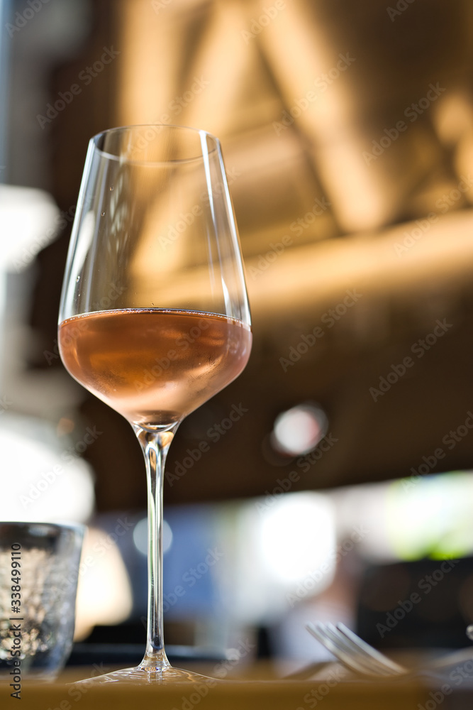 Glass with cold rose wine on a served table Glass with cold rose wine on a served table