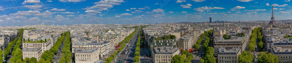 Fototapeta premium PARIS, FRANCE, EUROPE -Panoramic Aerial view of Paris, France as seen from the Arch of Triumph on a sunny day with white puffy clouds, shot August 4, 2015
