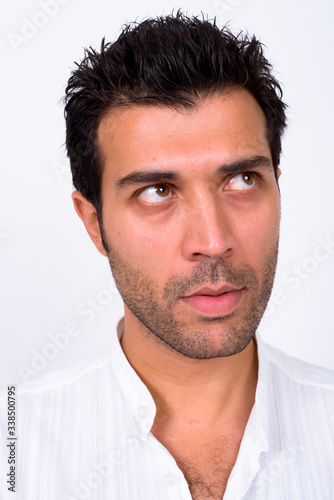 Face of handsome Turkish man thinking and looking up